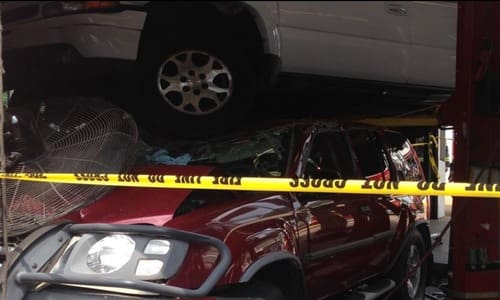 Mechanic Hit when woman crashes into his shop