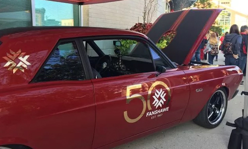 Pictured is the 1967 Ford Falcon, restored by Fanshawe students. The vehicle boasts custom seats embroidered with Fanshawe College falcon mascot, a new engine, a glossy red paint job, a powerful sound system and fuzzy dice on the rear-view.