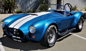 Pictured is one of the Genuine 427 Shelby competition Cobra race cars. ccording to the company, each competition chassis Cobra features a hand rolled aluminum body prepared by Cobra restorer Drew Serb and an original style interior. The engine is a period correct cast-iron Ford side oiler 427 with medium riser cylinder heads connected to a correct 4-speed gearbox with an authentic swept forward shifter.